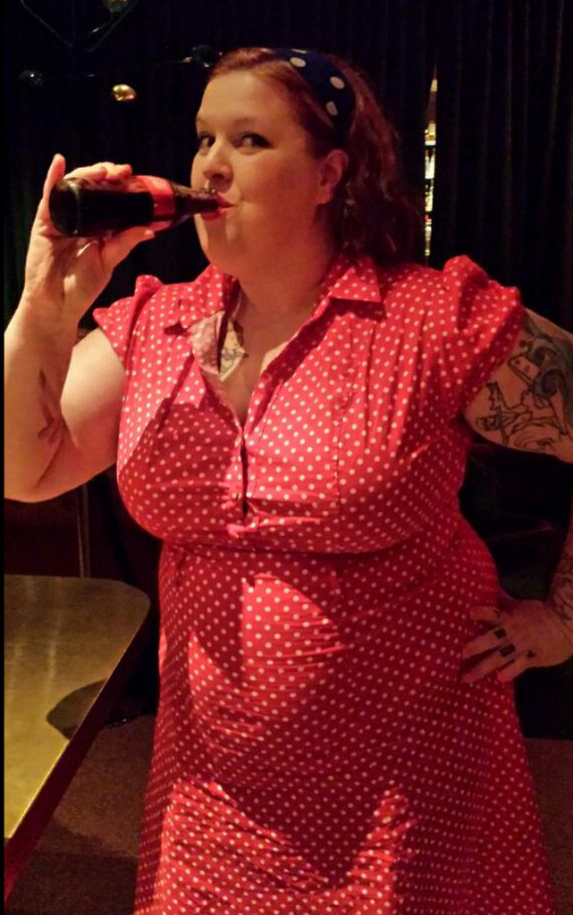 Me drinking a coke from a glass bottle, looking retro as hell and adorable.