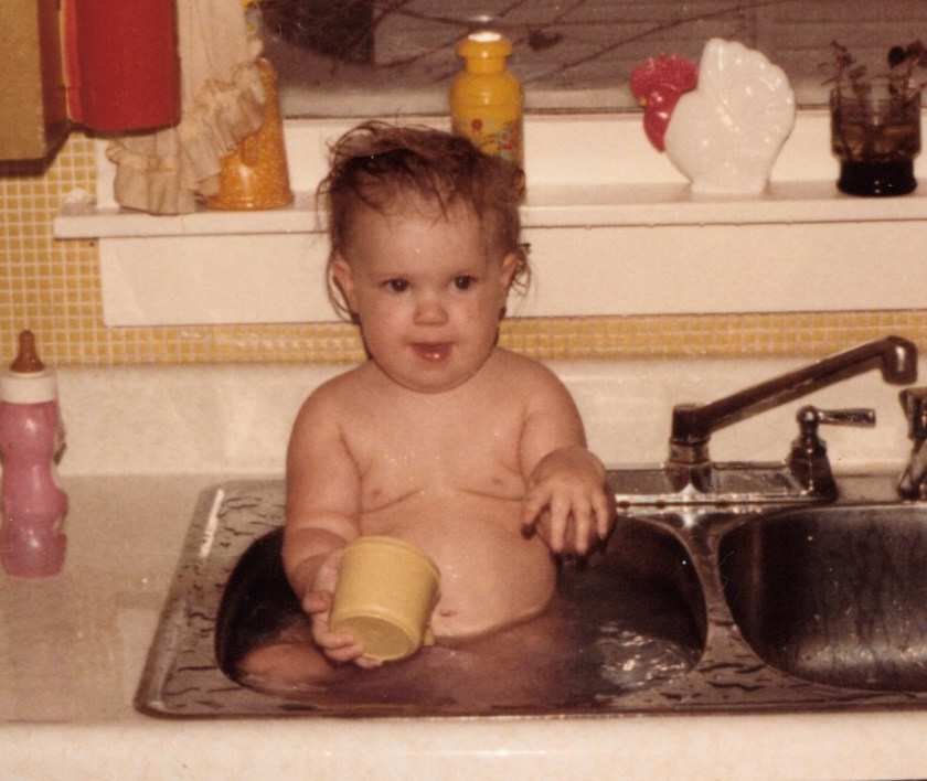Picture of me, a very fat baby, in the kitchen sink