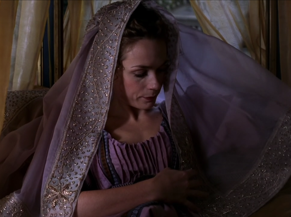 Octavia is wearing this really pretty lavender veil with all sorts of gold and beads decorating the hem, and a dress that's got all these vertical crinkles in it. It's super cool.