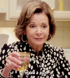 Lucille Bluth from Arrested Development, laughing and holding a drink in her hand as she says, "I made a pun".