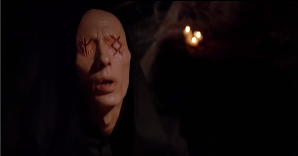 A dude in a hooded robe, with no eyes and big scars of nordic runes over where his eyes should be.