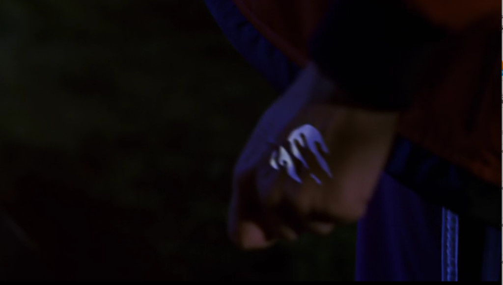 A small amount of glowing blue liquid splashed across the back of Buffy's hand.