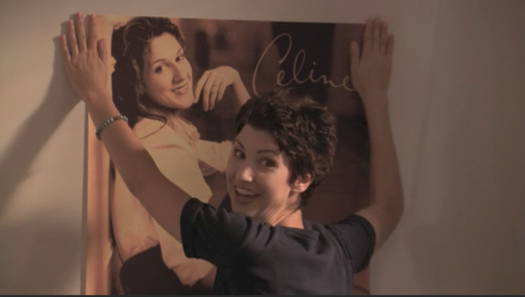 Cathy, hanging a giant poster of Celine Dion.