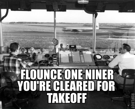 A black and white photo that appears to be from the 50s or 60s, of two air-traffic controllers watching a plane take off from inside the tower. The text reads, "Flounce one niner you're cleared for takeoff."