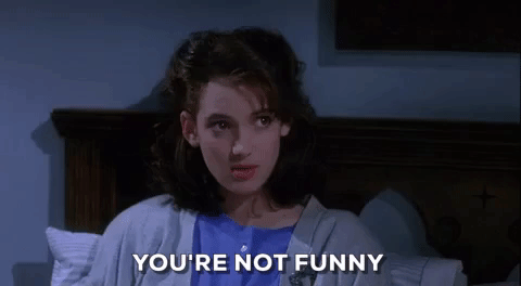 Winona Ryder in a scene from Heathers, saying "You're not funny."