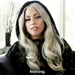 Lady Gaga wearing some kind of black veil and slowly shaking her head, saying, "Nothing."